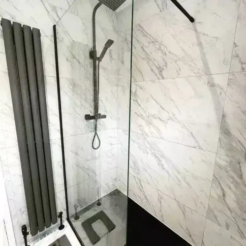A luxurious bathroom featuring a spacious walk-in shower with glass doors